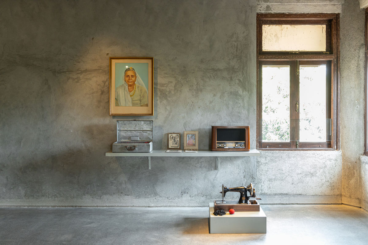 RADIO, BOX WITH CLOTHES, PORTRAIT OF KASTURI DEVI and SEWING MACHINE